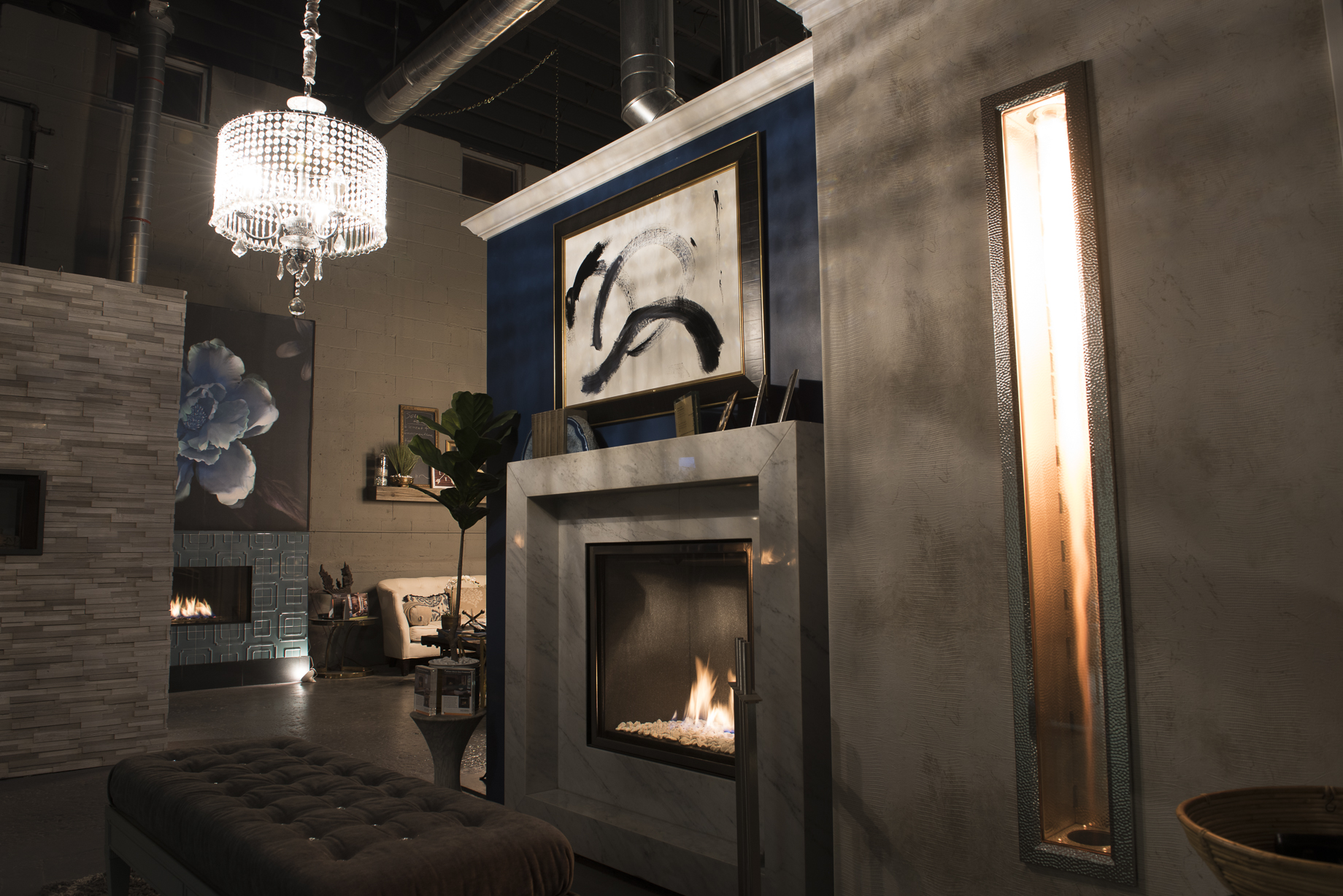 Ember Fireplaces showroom with traditional burning fireplace display and designer furnishings
