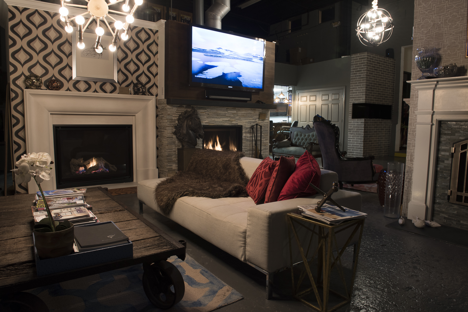 Wall of four burning fireplace inserts at Ember Fireplaces showroom in Edison NJ